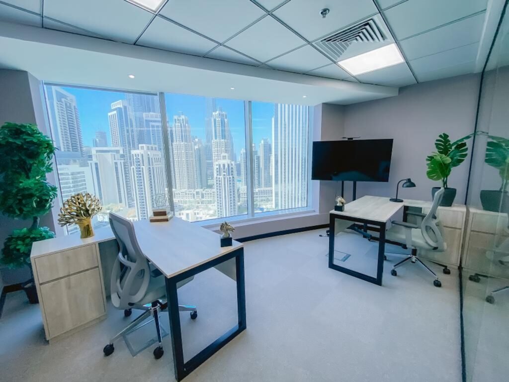 Sophisticated office layout with desks, chairs, and large window showing a city skyline.
