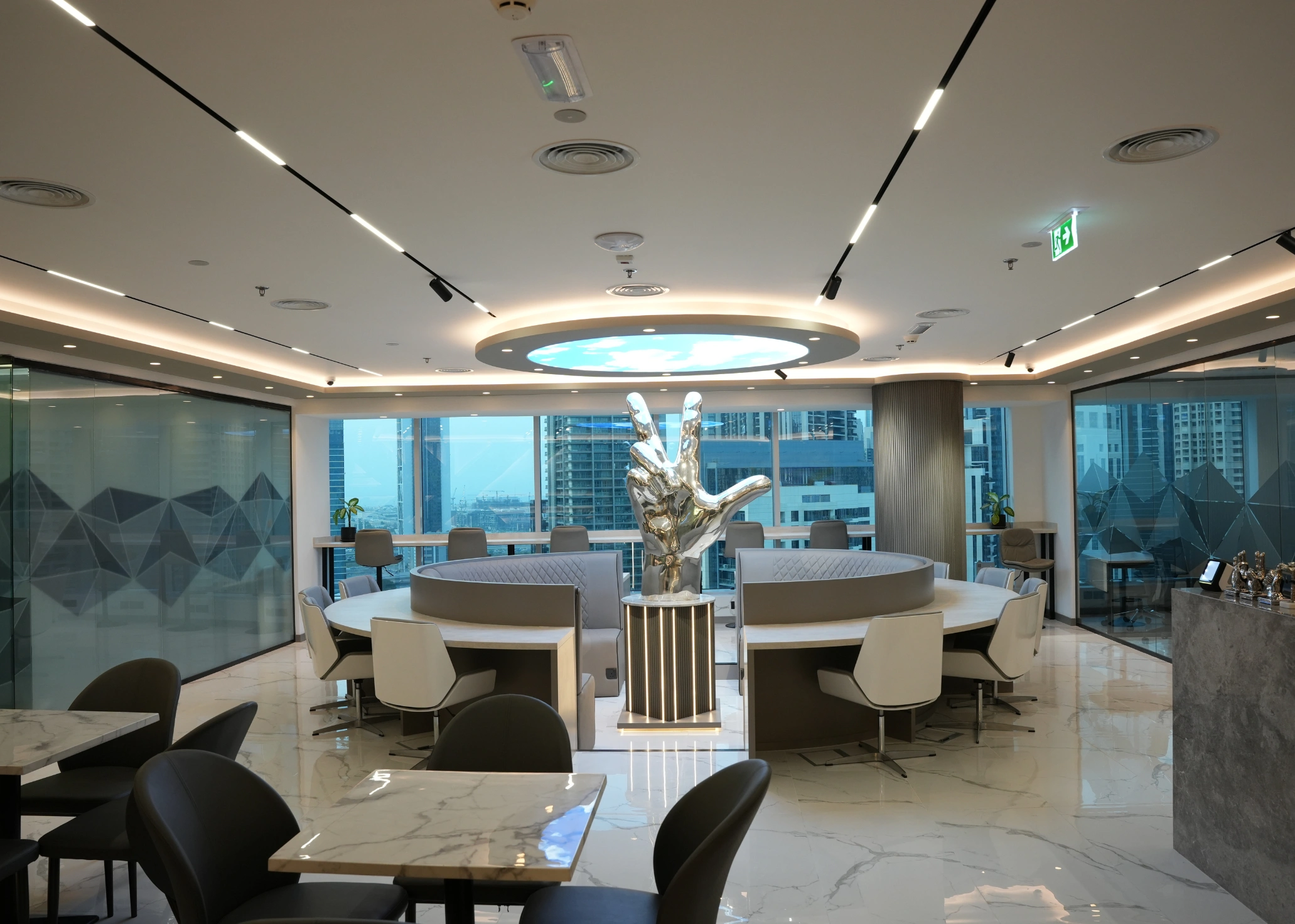 Modern office lounge with circular seating and peace sign sculpture.