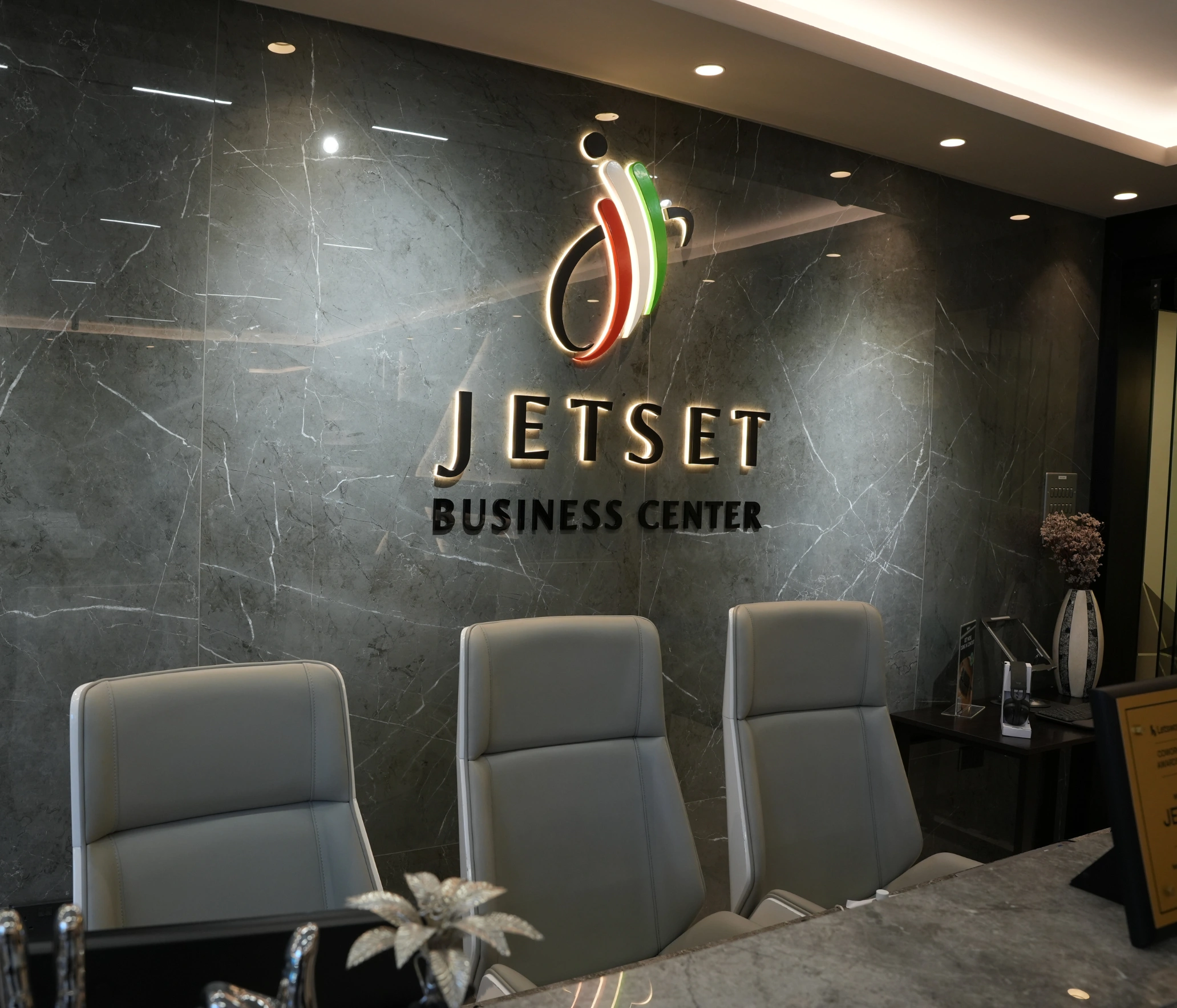 Sleek reception area with "JETSET BUSINESS CENTER" logo.